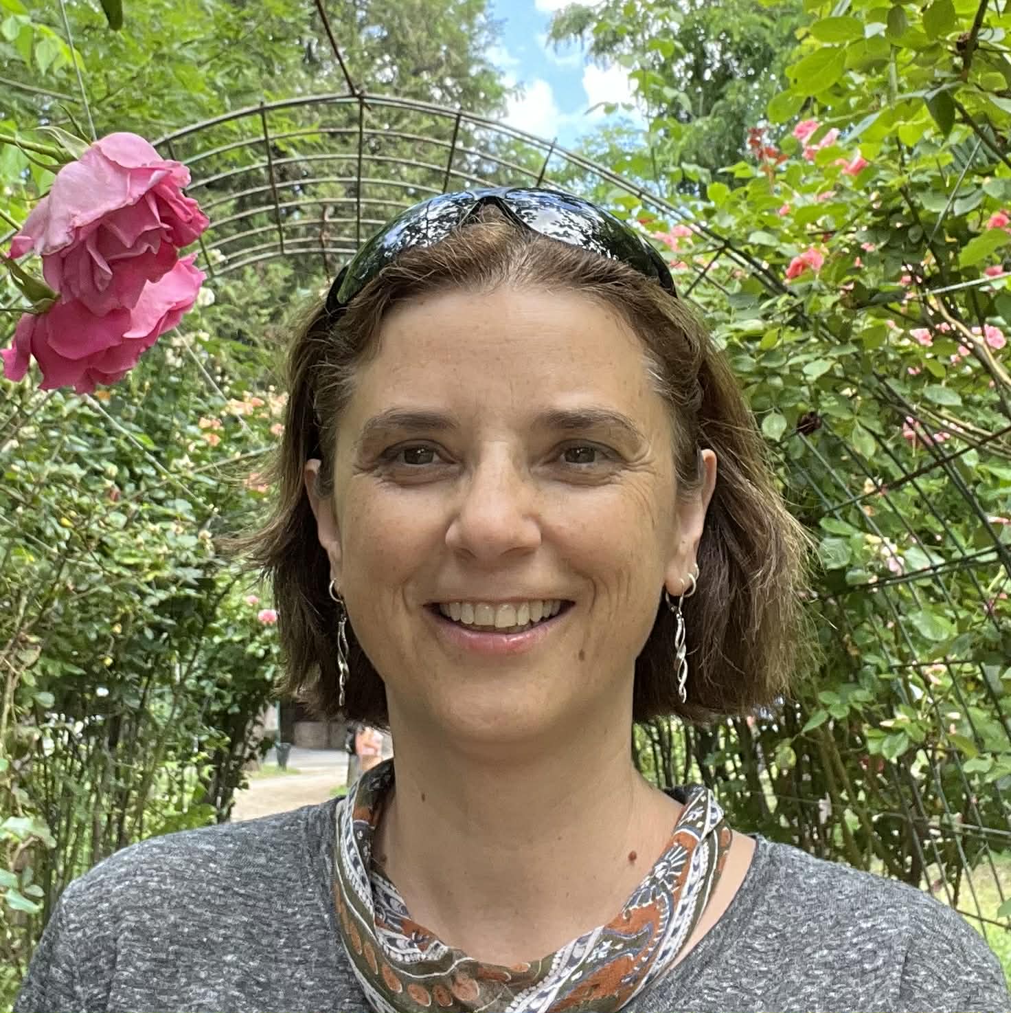 Andi Bartholomew smiling in a garden